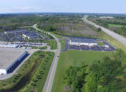 FedEx Ground (Lots S&T), ADT Customer Care Center (Lot V), ADT Service Dispatch Center (Lot U), eHealth Technologies (Lot F), counterclockwise, starting at bottom left; available space (Lots A-E) on right side of Thruway Park Drive in background; NYS Thruway along right.